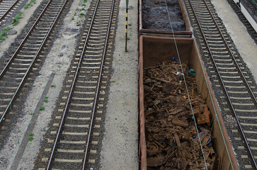 A rusted train container filled with mixed scrap is on its way to a recycling facility to recover valuable raw materials.
The container, heavily corroded and loaded with assorted scrap.