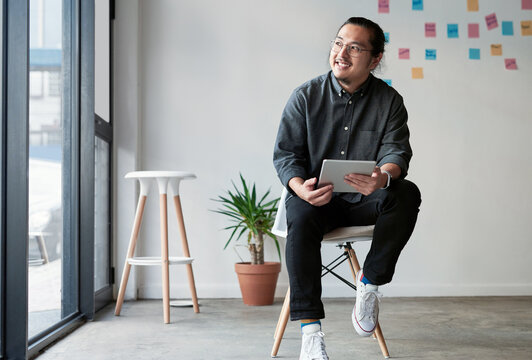 Tablet, thinking and Asian business man with creative idea, mindset or planning future. Vision, tech and happy worker in startup office for insight, solution or inspiration for design project online