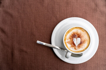 Top view of Latte coffee or cappuccino coffee in white cup with beautiful tree latte art