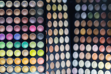 Variety of bright eyeshadow palettes on a store window