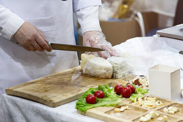 Staff cutting cheese at counter in market