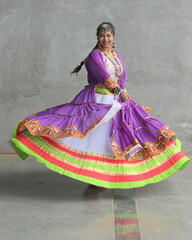 girl wearing chaniya choli, banjara shrug and playing garba in navratri. skirt full flare is rotating in the air round. wearing oxidized jewellery and long braid. Indian traditional garba dancer