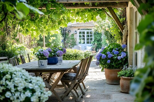 Fototapeta Patio Table with Hydrangea Flowers and Wooden Chairs