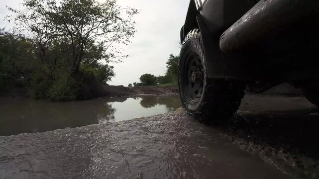 A 4x4 drives through the savannah in Kenya