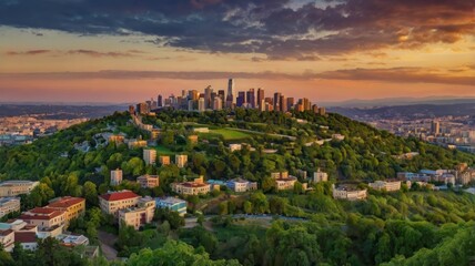 Green hill panorama of city at sunset