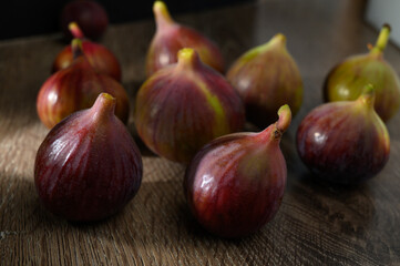 Ripe figs on a wooden background.