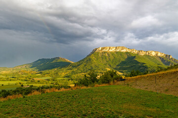 Fototapeta premium View to a mountain ridge in the French Maritime Alps with haze and heavy cloud cover.