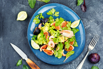 Fresh salad with shrimps, greens and figs.