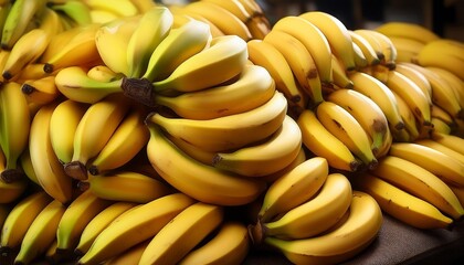 a large pile of ripe bananas sitting on top of a pile of other bananas in a pile on top of a pile of other bananas on top of a table