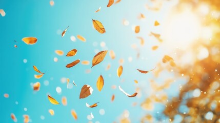 Obraz premium Golden leaves fluttering against a bright blue sky, creating a contrast between earth and sky.