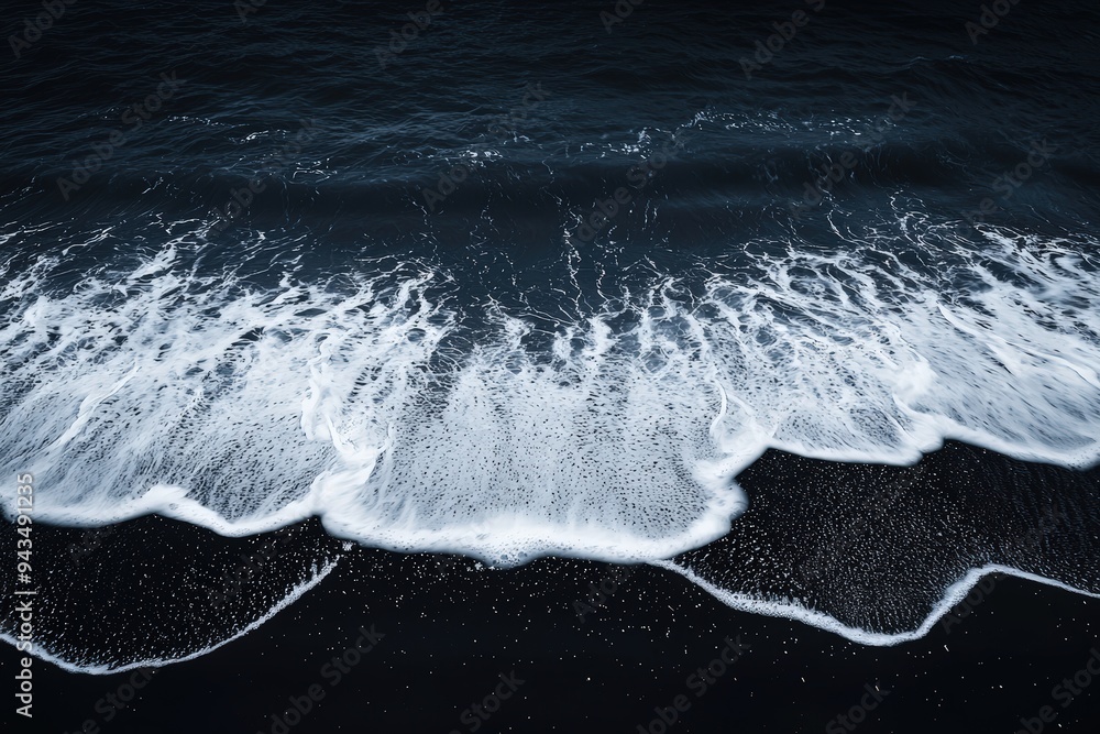 Wall mural Waves crashing on black sand