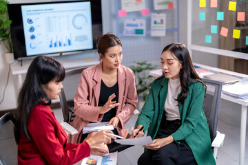 Three businesswomen having meeting analyzing financial documents