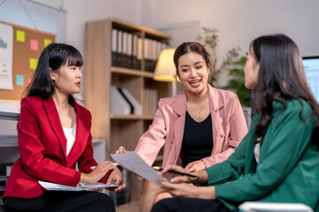 Businesswomen having meeting and discussing documents in office