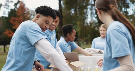 Volunteer, people and box with donation in park for community service, outreach and NGO project. Happy, team and package with food drive in nature for social responsibility, support and charity