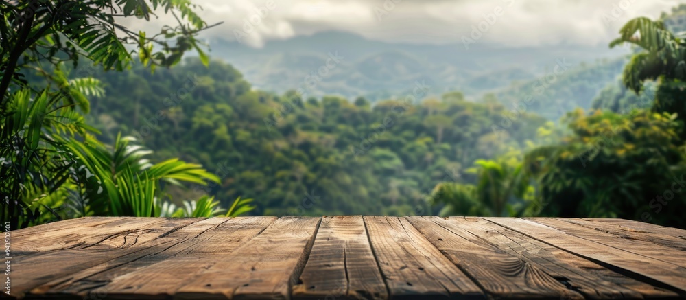 Poster wooden table with a blurred backdrop of mountains and lush greenery providing a copy space image for