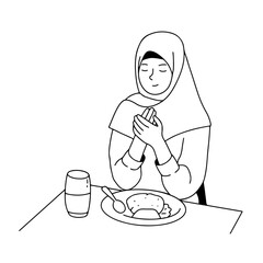 Muslim woman praying before eating at sahur