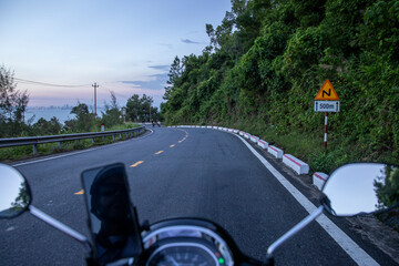 driving a motorbike on the road in the mountains