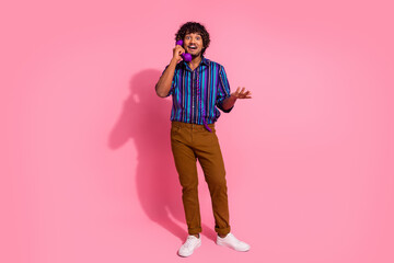 Full size photo of nice young man speak phone wear shirt isolated on pink color background