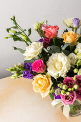 A beautiful bouquet of vibrant roses, eucalyptus, and delicate eustoma in white, pink, and purple hues, perfect for a summer anniversary or birthday celebration