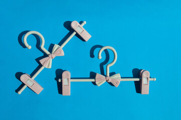 cute, pink, children's hangers with a bow. a clothes rack. wardrobe. background for the design. an element of the interior.