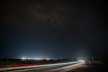 Long exposure photo from car light trails outside the city at night 
