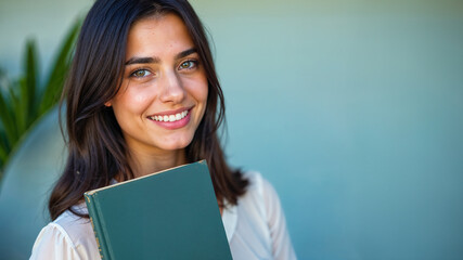 Fototapeta premium Happy Woman Embracing Lifelong Learning with a Book