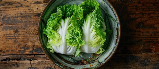 Obraz premium Chinese cabbage pickled and fermented in a pan with a wooden backdrop viewed from above providing a space for additional images
