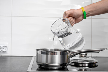 Filling the pot with cold water for cooking, clean drinking water