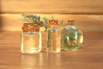 lavender essential oil in glass bottle on wooden background