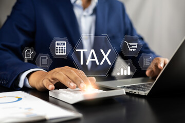 Tax and Vat concept. Government, state taxes concept. Businesman using calculator and laptop to complete Individual income tax return form online for tax payment. Data analysis, financial research.