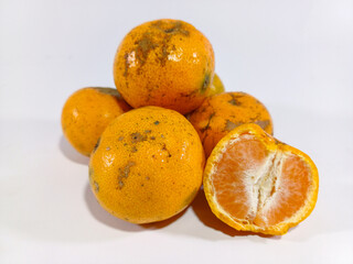 Stack of Oranges and a Half Orange Against a White Background: A Fresh and Vibrant Display, Highlighting the Juicy Interior of the Sliced Orange, Set Against a Crisp, Clean White Backdrop