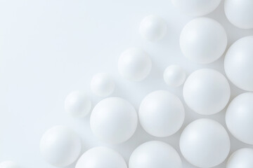 Aesthetic arrangement of white spheres on a soft white background, evoking a sense of tranquility and purity.