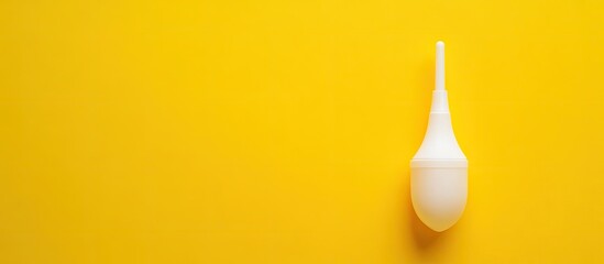 The idea of child medicine and hygiene A children s nasal aspirator against a yellow background Copyspace