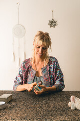 Smiling tarot reader mixing a deck of tarot cards