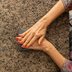 Top view of a tarot reader's hands over the tarot deck
