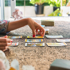 Side view of a tarot reader interpreting the cards