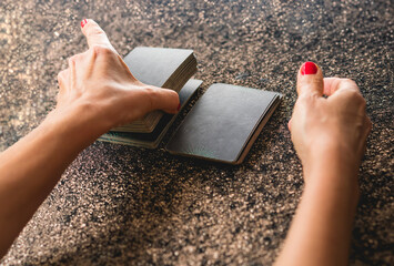 Shoulder view of a tarot reader cutting the tarot deck into three parts