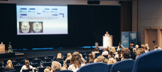 Speaker giving a talk on scientific conference. Audience at the conference hall. Business and Entrepreneurship concept