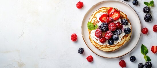Homemade cottage cheese pancakes topped with fresh berries on a white table Copy space