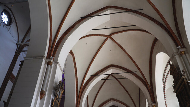 The arched ceiling of Riga Dome - architecture and stylistics. The vaulted ceiling is a masterpiece of medieval engineering, with intricate brickwork and elegant arches. - Powered by Adobe
