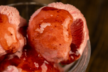 red strawberry-flavored ice cream in a glass bowl