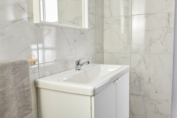 Bathroom white ceramic sink and stand style, mirror view with board and washing machine.