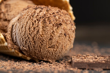 chocolate ice cream with chocolate chips on black slate