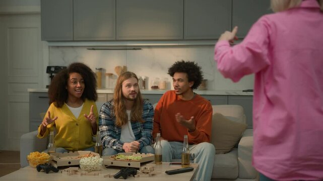 Diversity multiracial friends women men guys girls together guess word object play game fun entertainment at home Caucasian woman showing pantomime gesticulate forms explaining friendship weekend