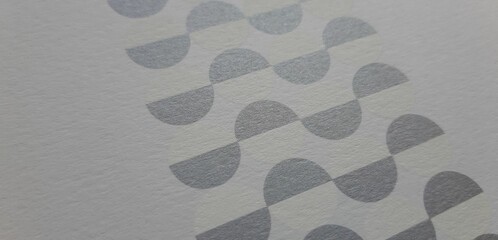 close-up of an abstract paper texture with geometric elements printed in white and silver, textured background and beautiful wallpaper with space for design