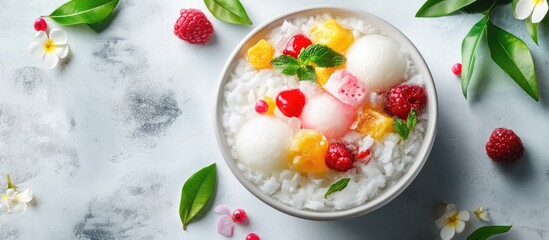 Es Campur also known as Mix Ice in a bowl is a traditional Indonesian drink made by combining ingredients such as fruits coconut grass jelly and sweet syrup With copyspace from a high view angle