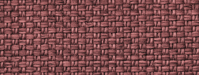 Texture dark red and wine background from woven textile with wicker pattern, macro. Vintage maroon fabric cloth,
