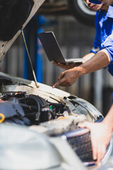 Auto mechanic checking engine operating system.