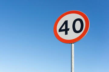 Speed limit sign. Traffic sign isolated on blue sky. 40 kmph background. Safety on the road with empty copy space.