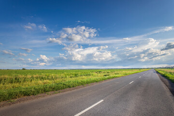 A long road with a clear blue sky above it